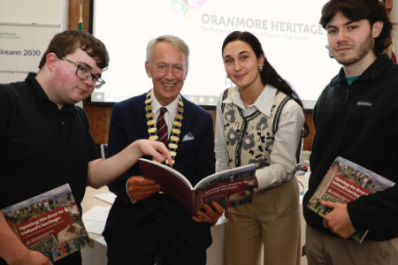 Cllr Liam Carroll, Cathaoirleach of the County of Galway and University of Galway students Dylan Reilly, Joseph Ennis and Natalie Cyrkle pictured with ‘Opening The Door To Ireland’s Heritage’, a Heritage Council publication which features their work on the ‘Galway County Heritage Trails’ project with Galway County Council